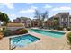 Community pool area featuring a swimming pool, hot tub, and lounging chairs at 17017 N 12Th St # 1106, Phoenix, AZ 85022