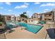 Community pool with lounge seating surrounded by lush landscaping and nearby condos at 17017 N 12Th St # 1106, Phoenix, AZ 85022
