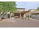 Enjoy this backyard with a covered patio, decorative rock landscaping, and a charming stone fireplace at 17062 N 184Th Dr, Surprise, AZ 85374