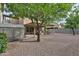 Spacious backyard with covered patio, storage shed, and decorative rock landscaping, perfect for outdoor enjoyment at 17062 N 184Th Dr, Surprise, AZ 85374