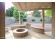 Covered patio features a stone fire pit and spacious backyard at 17062 N 184Th Dr, Surprise, AZ 85374