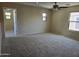 Bright bedroom featuring carpet flooring, neutral walls, ceiling fan, and multiple windows offering natural light at 17062 N 184Th Dr, Surprise, AZ 85374