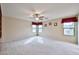 Bright bedroom featuring neutral walls, carpet, a ceiling fan, windows, and framed wall art at 17062 N 184Th Dr, Surprise, AZ 85374