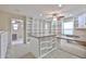 Versatile bonus room featuring a workstation, shelving, carpet, and ceiling fan with lights at 17062 N 184Th Dr, Surprise, AZ 85374