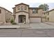 Charming two-story home with a covered entrance, attached two-car garage, and well-maintained landscaping at 17062 N 184Th Dr, Surprise, AZ 85374