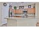 Bright kitchen features stainless appliances, granite counters, and light wood cabinetry at 17062 N 184Th Dr, Surprise, AZ 85374