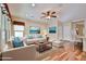 Comfortable living room featuring modern furnishings, hardwood floors, a ceiling fan, and abundant natural light at 17062 N 184Th Dr, Surprise, AZ 85374