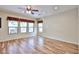 Bright living room with wood-look floors and backyard-facing windows, offering a view of the backyard at 17062 N 184Th Dr, Surprise, AZ 85374