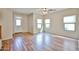 Bright living room featuring wood-look flooring and multiple windows for ample natural light at 17062 N 184Th Dr, Surprise, AZ 85374