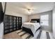 Bedroom with a patterned rug under a queen bed, next to a black bookshelf, and a window with blinds at 17916 N 183Rd Ave, Surprise, AZ 85374