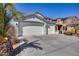 Beautiful home exterior with a three-car garage and mature palm tree at 17916 N 183Rd Ave, Surprise, AZ 85374