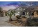Attractive home with a three-car garage, complemented by lush landscaping and a welcoming entryway at 17916 N 183Rd Ave, Surprise, AZ 85374