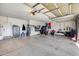 View of a spacious garage with motorcycle, tools, and a safe at 17916 N 183Rd Ave, Surprise, AZ 85374