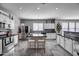 Bright kitchen featuring white cabinets, stainless steel appliances, and a center island with seating at 17916 N 183Rd Ave, Surprise, AZ 85374
