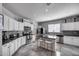 Modern kitchen featuring stainless steel appliances, a center island, and stylish tile backsplash at 17916 N 183Rd Ave, Surprise, AZ 85374