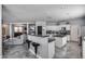 Modern kitchen and living room open layout featuring bar seating, white cabinets, and seamless entertaining space at 17916 N 183Rd Ave, Surprise, AZ 85374