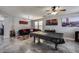 Bright living room with a pool table, modern decor, and a cozy black sofa at 17916 N 183Rd Ave, Surprise, AZ 85374