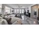 Modern living room with a large plush sofa, accent chairs, and stylish decor and view to kitchen and dining area at 17916 N 183Rd Ave, Surprise, AZ 85374