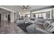 Bright and airy living area with comfortable seating, a gray color scheme, and an open layout connecting to the kitchen at 17916 N 183Rd Ave, Surprise, AZ 85374