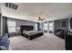 Spacious main bedroom features plush carpet, fan, and large windows for ample natural light at 17916 N 183Rd Ave, Surprise, AZ 85374