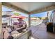 Outdoor patio featuring comfortable seating, a grill, shade umbrellas, and a view of the community pool at 17916 N 183Rd Ave, Surprise, AZ 85374