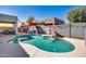 Inviting backyard pool area with red umbrellas, a hot tub, and outdoor seating at 17916 N 183Rd Ave, Surprise, AZ 85374