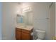 Well-lit bathroom features a vanity with a mirror and a toilet at 188 N Nueva Ln, Casa Grande, AZ 85194