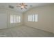 Spacious bedroom with plush carpet, two windows with plantation shutters, and a ceiling fan at 188 N Nueva Ln, Casa Grande, AZ 85194