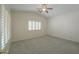 Tranquil bedroom featuring plantation shutters, ceiling fan, and plush carpeting at 188 N Nueva Ln, Casa Grande, AZ 85194