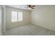 Bright bedroom with neutral carpet, window blinds, and a ceiling fan at 188 N Nueva Ln, Casa Grande, AZ 85194