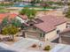 Beautiful single-Gathering home with desert landscaping, red tile roof, and attached two-car garage with golf course in the background at 188 N Nueva Ln, Casa Grande, AZ 85194