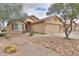 Inviting home with a well-maintained yard, desert landscaping, and a two-car garage at 188 N Nueva Ln, Casa Grande, AZ 85194