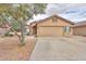 Attractive home featuring desert landscaping, a two-car garage, and a neutral-colored exterior at 188 N Nueva Ln, Casa Grande, AZ 85194