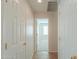 Hallway showing bedroom and closet doors with tile flooring, giving a sense of the home's layout at 188 N Nueva Ln, Casa Grande, AZ 85194