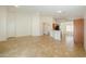 Bright and airy living room with tile flooring and neutral paint, leading into an eat-in kitchen at 188 N Nueva Ln, Casa Grande, AZ 85194