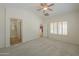 Spacious main bedroom features neutral carpet, ceiling fan and plantation shutters at 188 N Nueva Ln, Casa Grande, AZ 85194