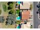 Aerial view capturing houses with pools, green lawns, mature trees, and street layout in a residential neighborhood at 19277 N 78Th Ln, Glendale, AZ 85308