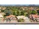 Community aerial view showcasing houses with red roofs, lush greenery, and a golf course in the background at 19277 N 78Th Ln, Glendale, AZ 85308