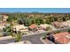 Aerial view of a home with tile roof in a lush neighborhood close to a golf course at 19277 N 78Th Ln, Glendale, AZ 85308
