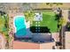 Overhead view of a backyard featuring a pool, patio area, artificial grass, and lush landscaping at 19277 N 78Th Ln, Glendale, AZ 85308