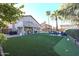 Expansive backyard with artificial turf, covered patio, pool, and putting green at 19277 N 78Th Ln, Glendale, AZ 85308