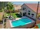 Aerial view of a backyard featuring a beautiful pool, lounge chairs, lush lawn, and a covered patio at 19277 N 78Th Ln, Glendale, AZ 85308