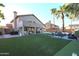 Large backyard featuring artificial turf, covered patio, pool, and outdoor seating area at 19277 N 78Th Ln, Glendale, AZ 85308
