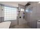 Modern tiled shower with glass block window and built-in shelving offering a spa-like experience at 19277 N 78Th Ln, Glendale, AZ 85308