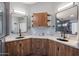 Spacious bathroom showcasing double sinks, a shared vanity, modern mirrors, and updated wood cabinets at 19277 N 78Th Ln, Glendale, AZ 85308