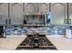 Modern kitchen detailing glass backsplash, quartz countertops and modern stove at 19277 N 78Th Ln, Glendale, AZ 85308
