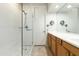 Modern bathroom featuring a tiled shower with glass door and vanity with ample counter space at 20802 N Grayhawk Dr # 1151, Scottsdale, AZ 85255