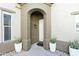 Inviting front entrance with potted plants, adding a touch of warmth and sophistication at 20802 N Grayhawk Dr # 1151, Scottsdale, AZ 85255