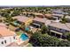 Drone shot displaying a home featuring a pool and well-maintained landscaping, nestled in a peaceful, tree-lined neighborhood at 21030 E Misty Ln, Queen Creek, AZ 85142