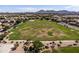 Expansive green community park surrounded by homes and mountain views at 21030 E Misty Ln, Queen Creek, AZ 85142